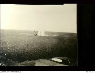 Bismarck Sea. 1943-03-03. Two water spouts from high level bombing, probably from USAAF Boeing B17 Flying Fortress aircraft, almost hide a Japanese merchant ship. It is also being strafed by a ..