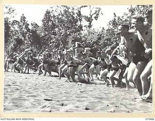 LAE, NEW GUINEA. 1944-08-27. COMPETITORS BREAKING THE LINE AT THE COMMENCEMENT OF THE CHARIOT RACE HELD DURING THE SURF CARNIVAL ORGANISED BY HQ, 5TH DIVISION AT MALAHANG BEACH. IDENTIFIED ..