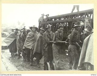 LAE, NEW GUINEA. 1944-08-09. TROOPS OF THE 20TH FIELD COMPANY, MANHANDLING THE LAUNCHING NOSE OF A LARGE BOX GIRDER INTO POSITION DURING THE REBUILDING OF THE BRIDGE ACROSS THE BUTIBUM RIVER. ..