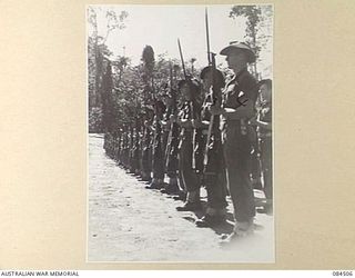 BOUGAINVILLE, SOLOMON ISLANDS, 1944-12-21. C COMPANY, 42 INFANTRY BATTALION PRESENTING ARMS DURING THE GENERAL SALUTE TO MAJOR-GENERAL W. BRIDGEFORD, GENERAL OFFICER COMMANDING 3 DIVISION. ..