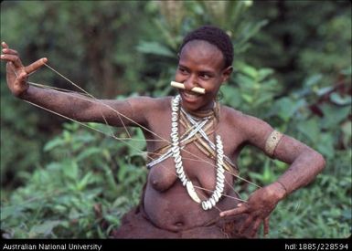 Woman showing string figure game