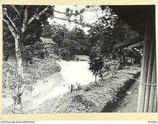 MILNE BAY, NEW GUINEA. 1944-04-20. LOOKING ACROSS THE CREEK FROM THE BARAGA NATIVE HOSPITAL TOWARDS THE HALF CASTE COMPOUND, AUSTRALIAN NEW GUINEA ADMINISTRATIVE UNIT