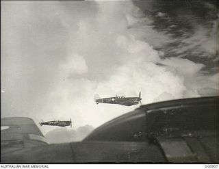 BISMARCK ARCHIPELAGO. 1944-03-28. AIRCRAFT, CODE NAMED UP-C, UP-W, OF NO. 79 (SPITFIRE) SQUADRON RAAF, IN FLIGHT OVER NEW BRITAIN EN ROUTE FROM KIRIWINA TO THE ADMIRALTY ISLANDS. PHOTOGRAPH TAKEN ..