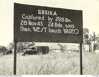 GUSIKA, NEW GUINEA. 1944-03-31. ONE OF MANY BATTLE SIGNS MARKING CONTACT WITH THE ENEMY, THIS SIGN RECORDS ACTIVITIES OF THE 2/28TH INFANTRY BATTALION ON THE 1943-11-28