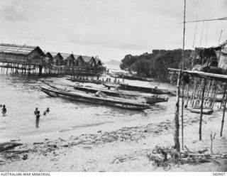 KONEKARU, PAPUA 1943-12-02. A SECTION OF THE VILLAGE SHOWING LARGE LAKATOIS (NATIVE BOATS) IN THE FOREGROUND