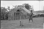 Yeria, Wanuma Census Division: smiling boy next to frame for house being built