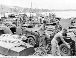 Jacquinot Bay, New Britain. 1945-02. Troops unloading stores at the end of the voyage. Nineteen ALC 40's and one ALC 120 Australian built landing craft of 41st Landing Craft Company, Royal ..