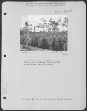 Joe E. Brown And Men Of The 38Th Bomb Group Singing 'God Bless America' During His Visit At Port Moresby, Papua, New Guinea. (U.S. Air Force Number 123428AC)
