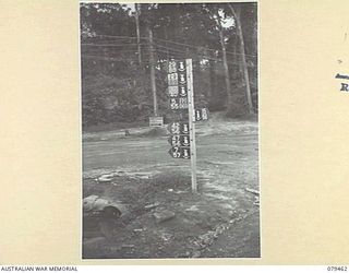 BOUGAINVILLE ISLAND. 1945-03-09. SIGNS ERECTED AT THE JUNCTION OF BOMBER LOOP AND CRAIG ROAD IN THE AREA CONTROLLED BY HEADQUARTERS, 3RD DIVISION