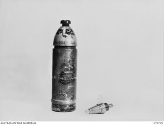 PORT MORESBY, PAPUA, NEW GUINEA, 1944-03-04. THE DISMANTLED VIEW OF A CAPTURED JAPANESE 75MM SHELL WITH FUSE. THE FINDING OF THIS HOLLOW CHARGE PROJECTILE SHOWED A RADICAL CHANGE IN JAPANESE ..