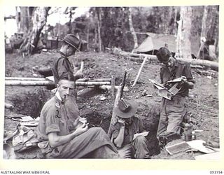 WEWAK AREA, NEW GUINEA, 1945-06-17. LT-COL W.S. HOWDEN, COMMANDING OFFICER, 2/8 INFANTRY BATTALION, RECEIVING REPORTS BY TELEPHONE OF THE ACTION ON HILL 2 BY B COMPANY. IDENTIFIED PERSONNEL ARE:- ..