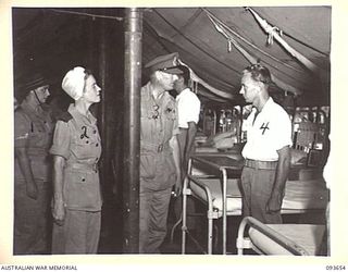 TOROKINA, BOUGAINVILLE, 1945-07-03. HIS ROYAL HIGHNESS, THE DUKE OF GLOUCESTER, GOVERNOR-GENERAL OF AUSTRALIA (3), SPEAKING WITH PRIVATE A.J. CAMP, 42 INFANTRY BATTALION (4), A PATIENT AT 2/1 ..