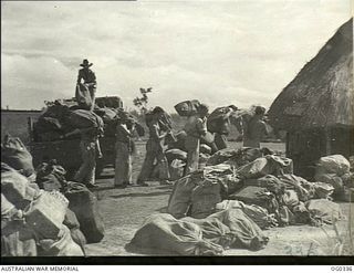 PAPUA-NEW GUINEA. C. 1942-12. MANY TONS OF RAAF CHRISTMAS PARCEL MAIL HAVE ALREADY BEEN DELIVERED TO ADVANCED NEW GUINEA BASES. BAGS ARE ARRIVING BY TRUCK AT THE POST OFFICE FOR SORTING PRIOR TO ..