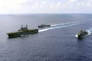 The amphibious assault ship USS SAIPAN (LHA 2) conducts an underway replenishment (UR) with the USNS LEROY GRUMAN and the amphibious assault ship USS AUSTIN (LPD 4)