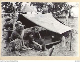 ULUPU, NEW GUINEA, 1945-07-09. CAPT G.M. FRY, D COMPANY, 2/5 INFANTRY BATTALION (3), DIRECTING & GUIDING BY PHONE, RAAF BEAUFORT BOMBERS IN FOR THEIR ATTACK ON ULUM, 350 YARDS FROM ULUPU RIDGE. ..