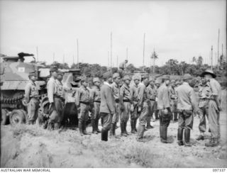 RAPOPO AIRSTRIP, NEW BRITAIN. 1945-09-28. JAPANESE TANK CREWS IN FRONT OF A LINE OF TANKS AT THE AIRSTRIP WHICH ARE BEING HANDED OVER TO AUSTRALIAN CREWS OF 2/4 ARMOURED REGIMENT. A TOTAL OF OVER ..