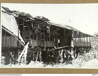 LOGAWENG, NEW GUINEA, 1943-10-25. THE LUTHERAN MISSION SCHOOL, ONE OF THE MANY BUILDINGS USED BY THE JAPANESE, DAMAGED AFTER IT HAD BEEN SUBJECT TO HEAVY ALLIED BOMBING RAIDS