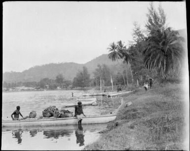 Laden canoe and a woman on the beach, New Guinea, ca. 1929 / Sarah Chinnery