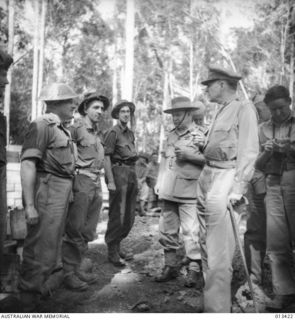 General Douglas Macarthur with men of the 2/3 Battalion. With him is General Blamey, Commander-in-Chief of the Land Forces in the Southwest Pacific Area. Identified left to right: NX100 Major Ian ..