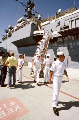 Crew members disembark from the miscellaneous flagship USS CORONADO (AGF-11) following the vessel's arrival in port at Naval Air Station, North Island, San Diego. The CORONADO, flagship for Commander, Third Fleet, will be arriving at its new home port after being stationed in Hawaii for almost 20 years