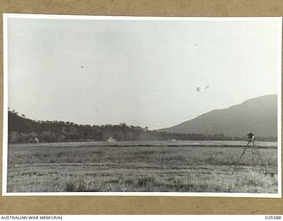 TOWNSVILLE, AUSTRALIA. 1942-11. GAS SHELL BURSTING OVER "GUINEA PIGS" DURING THE DEMONSTRATION GAS SHELL SHOOT BY 5TH FIELD REGIMENT, ROYAL AUSTRALIAN ARTILLERY