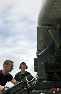 US Air Force (USAF) STAFF Sergeant (SSGT) John Beldin (left) and USAF SSGT Landon Favors both Weapons Loaders assigned to the 2nd Bomb Wing (BW), load a Conventional Air Launch Cruise Missile onto a USAF B-52H Stratofortress aircraft while deployed with the 7th Air Expeditionary Wing (AEW) at Andersen Air Force Base (AFB), Guam, during Operation ENDURING FREEDOM