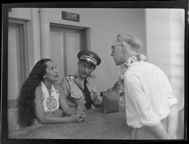 Unidentified man talking to custom officer and unidentified woman, Tahiti