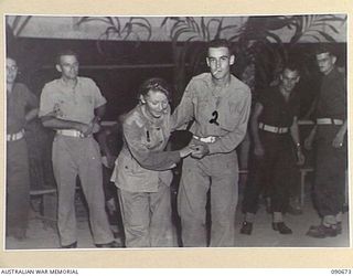 TOROKINA, BOUGAINVILLE. 1945-04-16. PRIVATE H. GATHERER, AUSTRALIAN ARMY MEDICAL WOMEN'S SERVICE, 2/1 GENERAL HOSPITAL (1), PARTNERS DRIVER E. JONES (2), DURING THE DANCE HELD AT THE OTHER RANKS ..