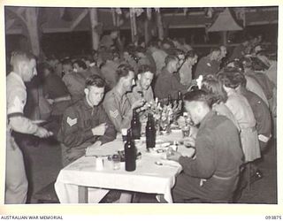 LAE AREA, NEW GUINEA, 1945-07-09. A SUPPER PARTY IN PROGRESS AT THE SERGEANTS' MESS, HEADQUARTERS 19 LINES OF COMMUNICATION AREA SIGNALS AFTER THE FINAL PERFORMANCE OF THE REVUE "OVER TO YOU", ..