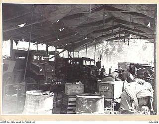 TOROKINA AREA, BOUGAINVILLE, SOLOMON ISLANDS. 1944-12-09. THE MOTOR TRANSPORT SHOP, 126 BRIGADE WORKSHOP SHOWING TROOPS ENGAGED IN A WIDE RANGE OF MECHANICAL CONSTRUCTION AND REPAIR