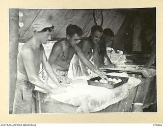 JACQUINOT BAY, NEW BRITAIN. 1944-11-08. BAKERS OF THE 14/32ND INFANTRY BATTALION PREPARING BREAD ROLLS FOR BAKING IN THE UNIT BAKERY. IDENTIFIED PERSONNEL ARE: V36839 PRIVATE J.P. DEVANEY (1), ..