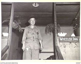 PALMALMAL, NEW BRITAIN. 1945-08-17. gRACIE FIELDS, NOTED LANCASHIRE VOCALIST AND COMEDIENNE, AT THE ENTRANCE TO THE MATRON'S COTTAGE, 2/8 GENERAL HOSPITAL, AFTER AN EXCITING TRIP THROUGH HEAVY RAIN ..
