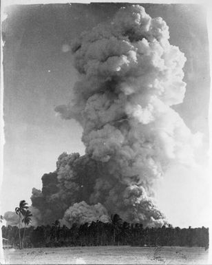Column of smoke rising over trees during volcanic eruption, Rabaul, New Guinea, 1937 / Sarah Chinnery