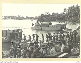 SARANG, NEW GUINEA. 1944-05-31. TROOPS AND STORES OF THE 37/52ND INFANTRY BATTALION BEING LANDED FROM AMERICAN LANDING BARGES. THE AREA IS USED AS A FORWARD BASE DURING THE PREPARATIONS FOR THE ..