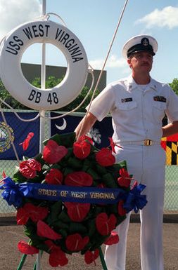 CPO Terry Clancy stands by the memorial wreath for the USS WEST VIRGINIA (BB-48) during Survivor's Day ceremonies at the USS ARIZONA Memorial Visitors Center. The event honors the sailors and Marines of the battleships that were sunk or damaged in the Dec. 7, 1941, attack on Pearl Harbor