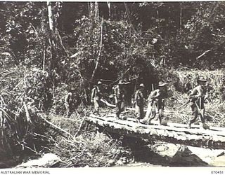 FARIA RIVER, NEW GUINEA, 1944-02-15. MEMBERS OF "A" COMPANY OF THE 57TH/60TH INFANTRY BATTALION CROSSING A BRIDGE IN THEIR MARCH UP THE FARIA RIVER TO RELIEVE THE 2/9TH INFANTRY BATTALION AT THE ..