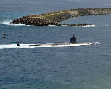 The LOS ANGELES class Attack Submarine USS TUCSON (SSN 770) glides past the mouth of Apra Harbor, Guam. The attack submarine has twelve launch missile tubes for Tomahawk cruise missiles to provide defense capabilities and retractable bow planes to give the vessel increased maneuverability. With it's stealth design, endurance, and mobility the TUCSON is able to operate in all ocean areas of the world. She is the 59th of her class and homeported out of Pearl Harbor, Hawaii