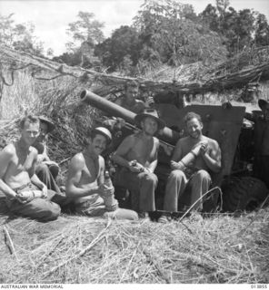 1942-12-16. PAPUA. GONA. 55/53RD INFANTRY BATTALION CREW OF 25 POUNDER UNIT NEAR THE MUZZLE OF THEIR GUN. WHEN THE 25 POUNDERS FIRST ARRIVED BY PLANE AND OPENED FIRE ON THE JAPANESE, TROOPS STOOD ..