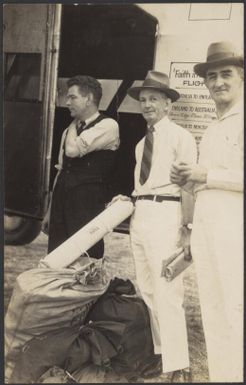 Portrait of Charles Ulm, E. Imlay and L. Drewe with mail bags in front of Faith in Australia plane VH-UXX, Port Moresby, Papua New Guinea, 26 July 1934