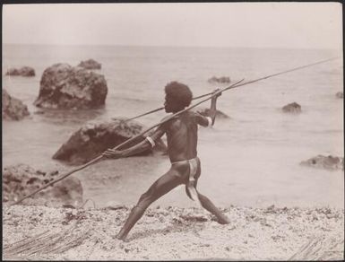 A man demonstrating spear fighting on a beach at Ahia, Ulawa, Solomon Islands, 1906, 2 / J.W. Beattie