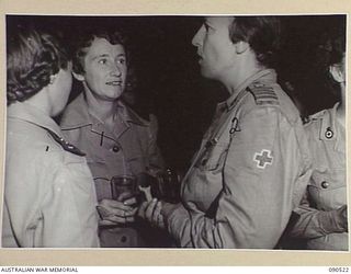 LAE, NEW GUINEA. 1945-03-26. LADY WAKEHURST (2), WITH MATRON G.E.M. BRINDLEY (1), DURING HER VISIT TO THE SISTERS MESS, 2/7 GENERAL HOSPITAL