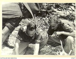 DANMAP RIVER AREA, NEW GUINEA. 1944-12-31. WX18 LIEUTENANT COLONEL H.M. BINKS, COMMANDING OFFICER (1) STUDYING A MAP OF THE BUT AREA DURING THE ATTACK ON THE ENEMY WHICH RESULTED IN THE CAPTURE OF ..