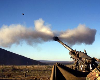 A round from an M-198 Howitzer from 1ST Battalion, 12th Marines, blasts over a dormant steam vent in the Pohakuloa Training Area, Hawaii, during a Hawaiian Combined Arms Operation