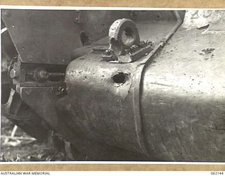 SCARLET BEACH AREA, NEW GUINEA. 1943-12-21. SHOT SHOWING THE PENETRATIVE POWERS OF 12 ARMOUR PIERCING 37MM SHELLS FIRED FROM A RANGE OF APPROXIMATELY 30 YARDS AT A MATILDA TANK IN THE 1ST ..