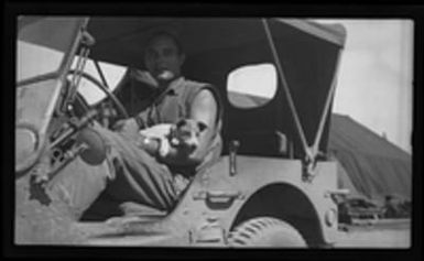 [Elmer A. Ball and Foo Foo the Dog in jeep]