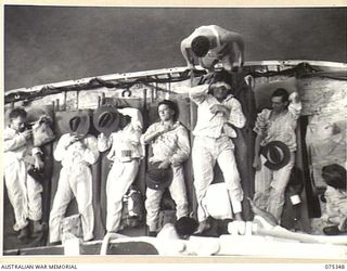 LAE, NEW GUINEA. 1944-08-18. SICK AND WOUNDED AUSTRALIAN ARMY PERSONNEL BEING TRANSFERRED FROM THE SHIP'S LIFEBOAT THE 2/1ST HOSPITAL SHIP, "MANUNDA"