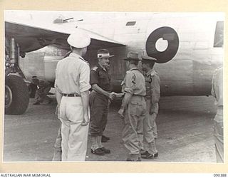 JACQUINOT BAY, NEW BRITAIN. 1945-04-08. SENATOR J.M. FRASER, ACTING MINISTER FOR THE ARMY (1), AT THE AIRSTRIP WITH MAJOR GENERAL A.H. RAMSAY, GENERAL OFFICER COMMANDING 5 DIVISION (3), AND MAJOR ..