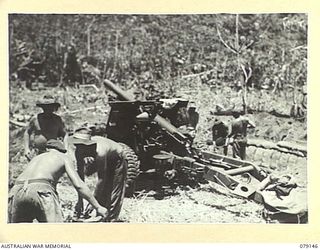 TSIMBA AREA, BOUGAINVILLE ISLAND. 1945-02-16. TROOPS OF THE 4TH FIELD REGIMENT, UNLOADING AMMUNITION, FILLING SANDBAGS AND DIGGING PITS FOR THEIR 25 POUNDERS SOON AFTER THEIR LANDING AT PUTO BEACH