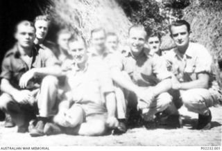 Tol, New Britain. Late 1945. Informal group portrait of some of the members of the "M" Special unit, and other military personnel who were responsible for paying local natives for their services to ..