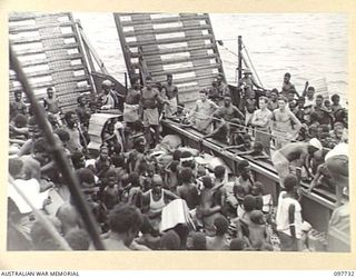 KAHILI, BOUGAINVILLE. 1945-10-02. TWO AUSTRALIAN LANDING CRAFT LOADED WITH NATIVES WHO WERE BROUGHT BACK BY AUSTRALIAN NEW GUINEA ADMINISTRATIVE UNIT TO THE BUIN AREA. THE JAPANESE EVACUATED THE ..